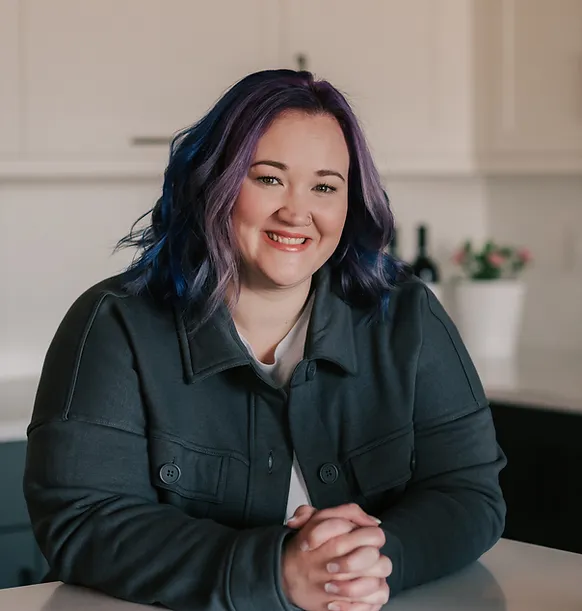 A trauma therapist smiling warmly, symbolizing empathy, understanding, and the supportive care provided in trauma therapy.