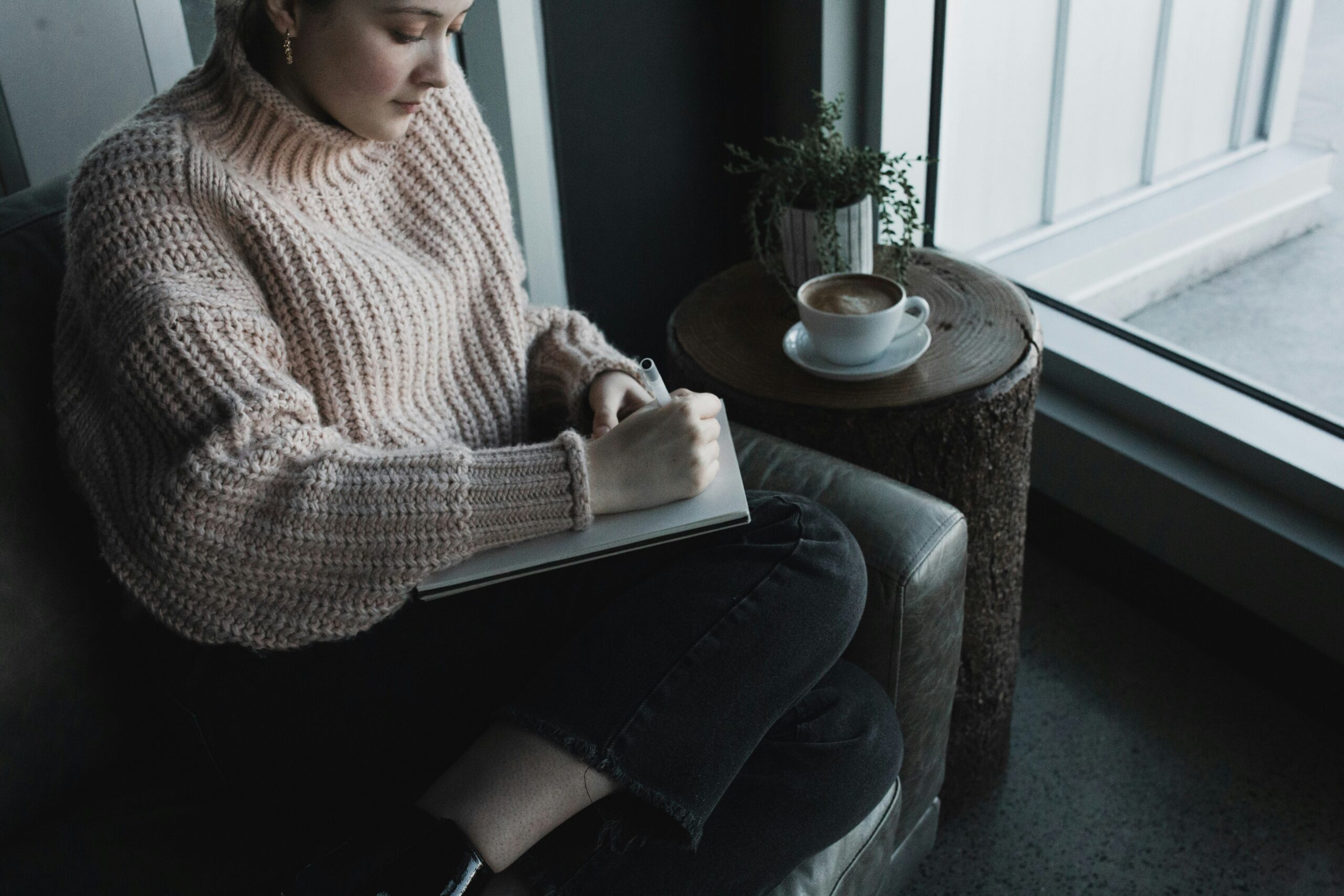 A cozy moment of journaling that mirrors the reflective nature of Internal Family Systems therapy. This image represents how clients at Ignite Counselling explore their inner world, meet their parts with kindness, and strengthen access to Self‑energy through guided reflection.